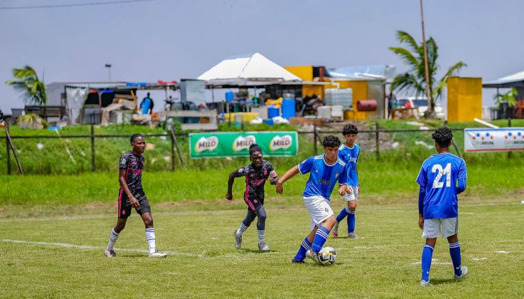 A scene from the opening game in the 9th edition of the Milo Secondary Schools Football Championship between Marian Academy (blue) and Eats Ruimveldt