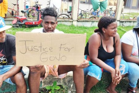 A young man with a placard
