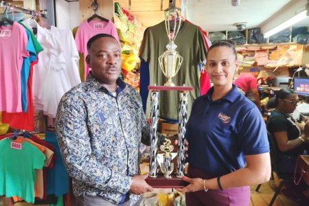 WSUCC President, Franklin Wilson, receives the trophy from Trophy Stall Representative, Saleema Hussain.