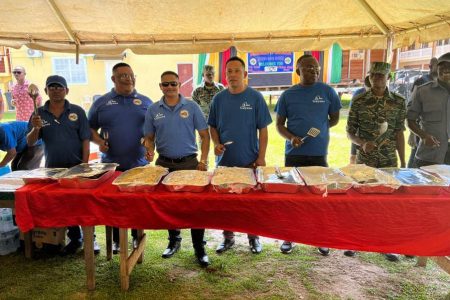 Men on Mission (MoM) in Region One yesterday prepared food as part of international women’s day celebrations. It formed part of countrywide observances by MoM. (Police photo)