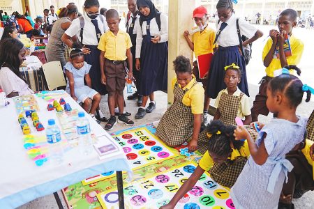 Pupils and students engrossed in an interactive exhibit  (Ministry of Education photo)