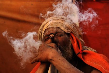 A Hindu holy man in Kathmandu smokes a chillum, a traditional clay pipe, on March 6, the eve of a festival honoring the god Shiva. Prkash Mathema /AFP/Getty Images