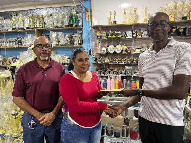 Monique Allicock (centre), Sales Representative of Trophy Stall’s South Road branch, hands over the sponsorship cheque to Lusignan Golf Club’s PRO Paton George in the presence of the Club’s Secretary Chet Bowling