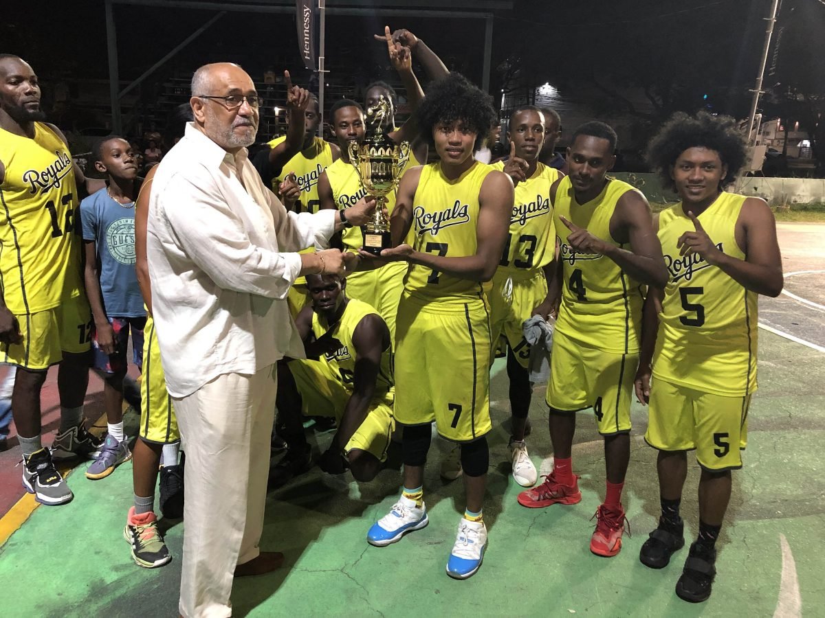 Chief Executive Officer of Leh We Ride Roy Spooner presenting the winner’s trophy to the captain of Victory Valley Royals Yannick Tappin.