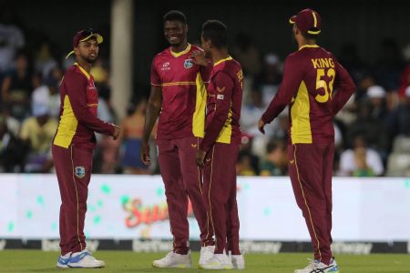 Indies cricketers from left, Nicholas Pooran, Alzarri Joseph, Akeal Hosein and Brandon King celebrate the
fall of a South African batsman’s wicket during Saturday’s second ODI which the West Indies won by 48 runs
