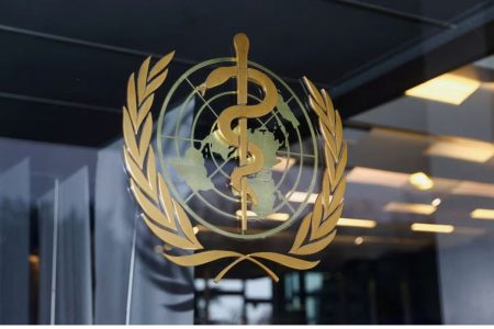 The World Health Organization logo is pictured at the entrance of the WHO building, in Geneva, Switzerland, December 20, 2021. REUTERS/Denis Balibouse