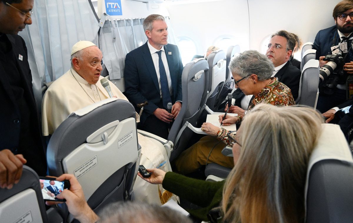 Pope Francis holds a news conference as he returns to the Vatican following his apostolic journey to Hungary, aboard the plane, April 30, 2023.  Vincenzo Pinto/Pool via REUTERS