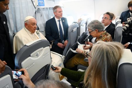 Pope Francis holds a news conference as he returns to the Vatican following his apostolic journey to Hungary, aboard the plane, April 30, 2023.  Vincenzo Pinto/Pool via REUTERS