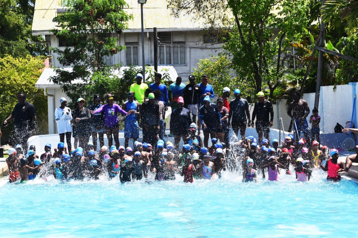 Participants and coaches posing for the camera during the morning session of the Easter Vacation Swimming Programme at the Colgrain Swimming Pool, Camp Street