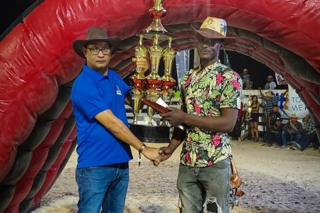 Rodeo King Joshua Gaskin receiving his trophy (A path to travel photo)
