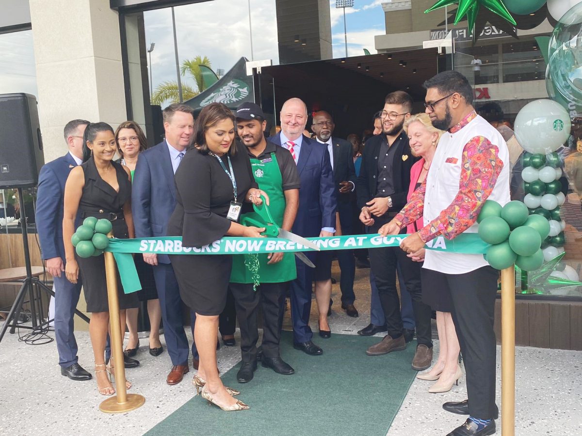 President Irfaan Ali (right), Marketing Manager of the Amazonia Mall, Cindy Ramnarine and other officials at the cutting of the Starbucks Café opening ribbon.