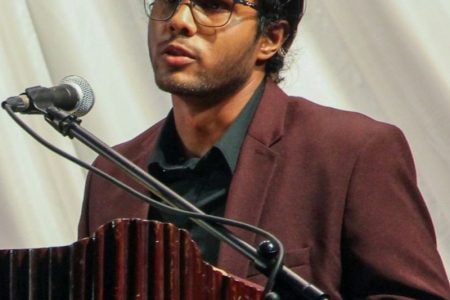 Samir Mohammed performing his poetry at the Guyana Prize for Literature awards ceremony