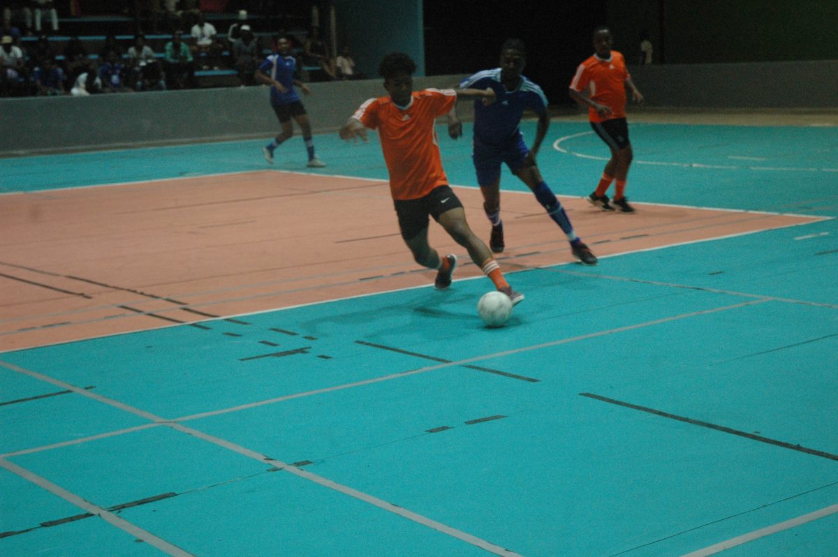 Action between Showstoppers (orange) and Leopold Street in the One Guyana Futsal Championship
