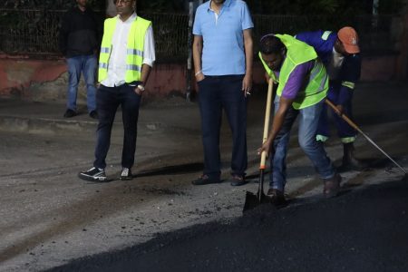 Contractor Junior Sammy looks at his workers during a road paving exercise along Duke Street, Port-of-Spain, in January. ROBERTO CODALLO