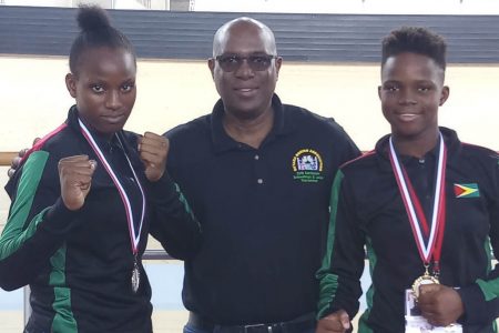WORLD RATED! President of the Guyana Boxing Association Steve Ninvalle, centre is flanked by Abiola, left and Alesha Jackman