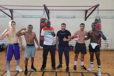  Olympian, Keevin Allicock (second from left), Coach, Terrence Poole (third from left) along with Sportsman
of the Year, Desmond Amsterdam (far right) posing with some other participants of the high level training
camp following a sweat drenched session in Tashkent, Uzbekistan.