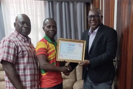  Historic! GBA President Steve Ninvalle (right) presents the IBA Cutman Technician Certification to Three-Star Coach, Sebert Blake following the successful completion of the programme. Also in the photo is GBA executive Seon Bristol.
