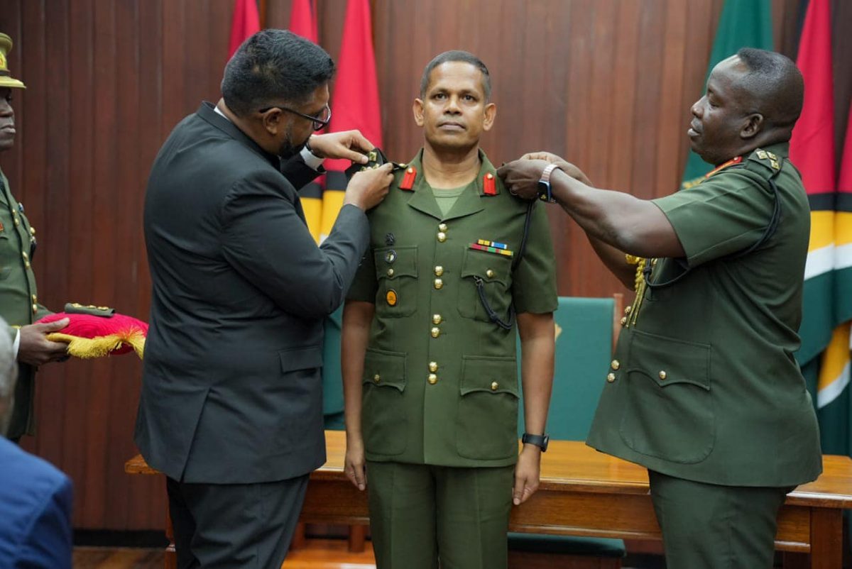 Brigadier Omar Khan being decorated today by President Irfaan Ali (left) and GDF Chief of Staff Godfrey Bess. (Office of the President photo)