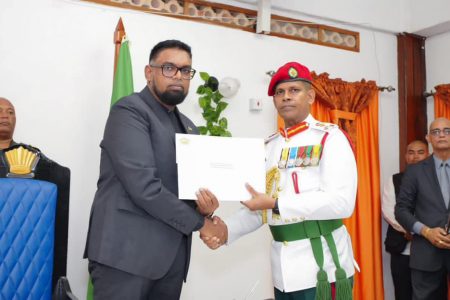 Brigadier Omar Khan (right) receiving his instrument of appointment from President Irfaan Ali.(Office of the President photo)