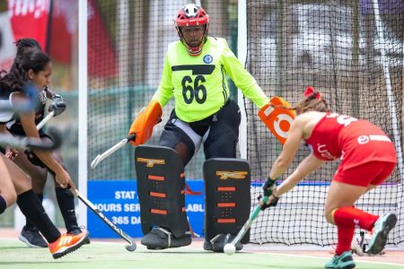  Guyana’s goalkeeper staves off an attack by a Chilean player.