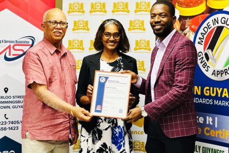 Banks DIH Chairman Clifford Reis (left) receiving the certificate from John Edghill (GNBS photo)