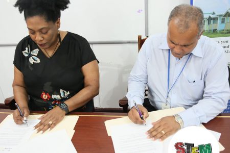 STEMGuyana Director Karen Abrams and FFTP (Guy) Inc CEO Kent Vincent sign the MOU