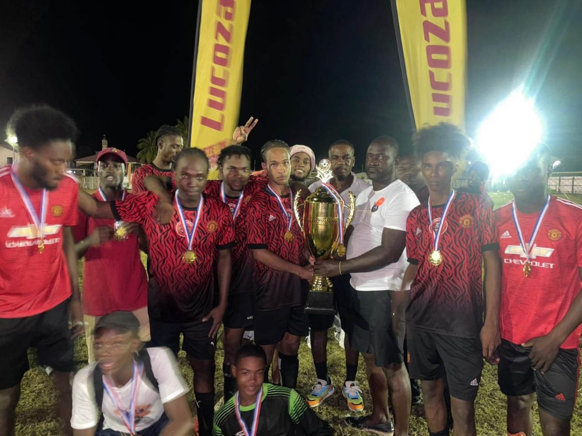 John Gonsalves receives the championship trophy from the tournament organizer in the presence of teammates