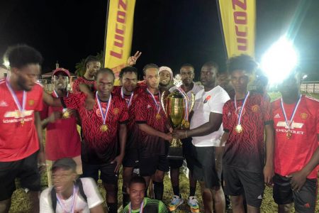 John Gonsalves receives the championship trophy from the tournament organizer in the presence of teammates