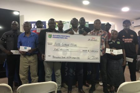 GFF General Secretary Ian Alves displaying the participation grant in the presence of Elite League team officials which will be afforded to the competing sides prior to the start of Season Five 