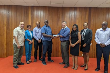 Vice-President Philip Fernandes in centre hands over
sponsorship cheque to Terrence Poole, Technical Director of the Guyana Boxing Association. The pair is flanked by Executive Members of the Guyana Olympic Association (from left to right) Michael Singh, Emily Ramdhani, Godfrey Munroe, Terrence Poole, Philip Fernandes, Vidushi Persaud-McKinnon, Cristy Campbell and Steve Ninvalle.