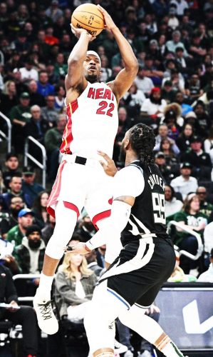 Milwaukee, Wisconsin, USA; Miami Heat forward Jimmy Butler (22) shoots the ball against Milwaukee Bucks forward Jae Crowder (99) in the first half during game one of the 2023 NBA Playoffs at Fiserv Forum yesterday. Mandatory Credit: Michael McLoone-USA TODAY Sports