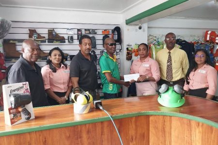 Veteran marksman Ransford Goodluck receives the sponsorship cheque from Nyeesha
Joseph, accountant of Industrial Safety and Supplies Inc.