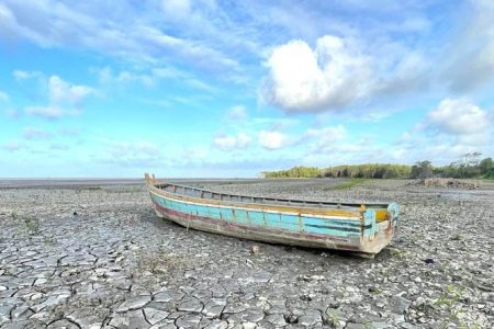 An abandoned fishing boat on the mudflats of the Rose Hall Town beach. (David Papannah photo)