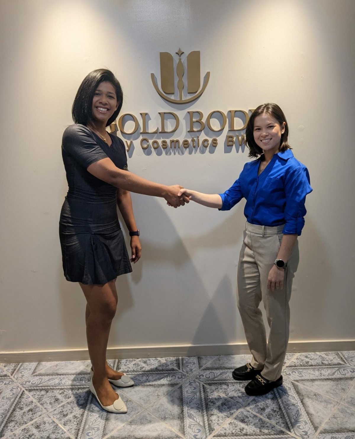 Camille Da Cunha (left), Executive Director of Gold Body by Cosmetics BW presenting to representative of the Kares Caribbean Crossfit Championship, Mary Fung-A-Fat 