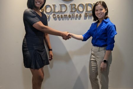 Camille Da Cunha (left), Executive Director of Gold Body by Cosmetics BW presenting to representative of the Kares Caribbean Crossfit Championship, Mary Fung-A-Fat 