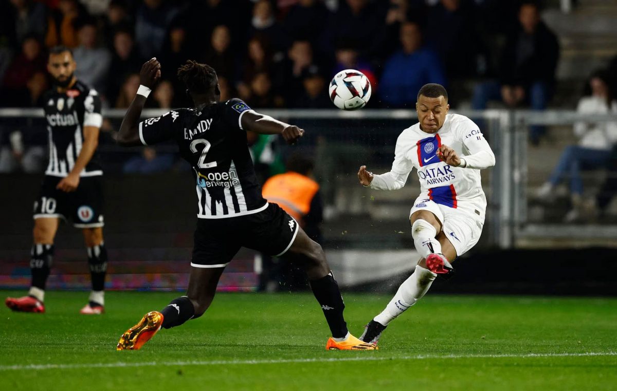 Paris St Germain’s Kylian Mbappe in action with Angers’ Batista Mendy REUTERS/Stephane Mahe