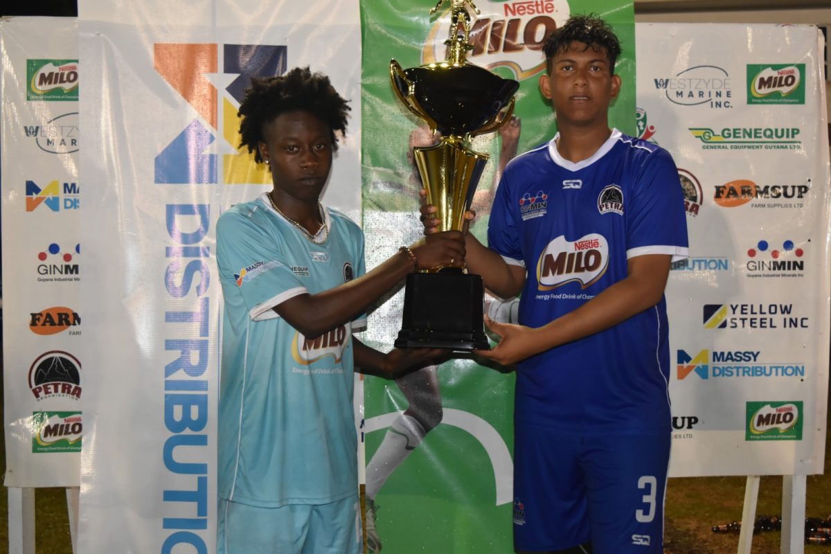 Holy Grail! Chase Academy captain Seon Cato (left) and skipper of Santa Rosa Roy Van Sluytman posing with the Milo Secondary School Championship Trophy
