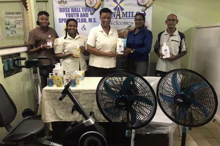 Saintalene Foster hands over the RHTYSC donation to Yonette Yaw in the presence of the staff of the Therapy Unit and Robby Kissoonlall of the club.

