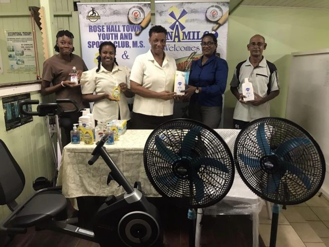 Saintalene Foster hands over the RHTYSC donation to Yonette Yaw in the presence of the staff of the Therapy Unit and Robby Kissoonlall of the club.
