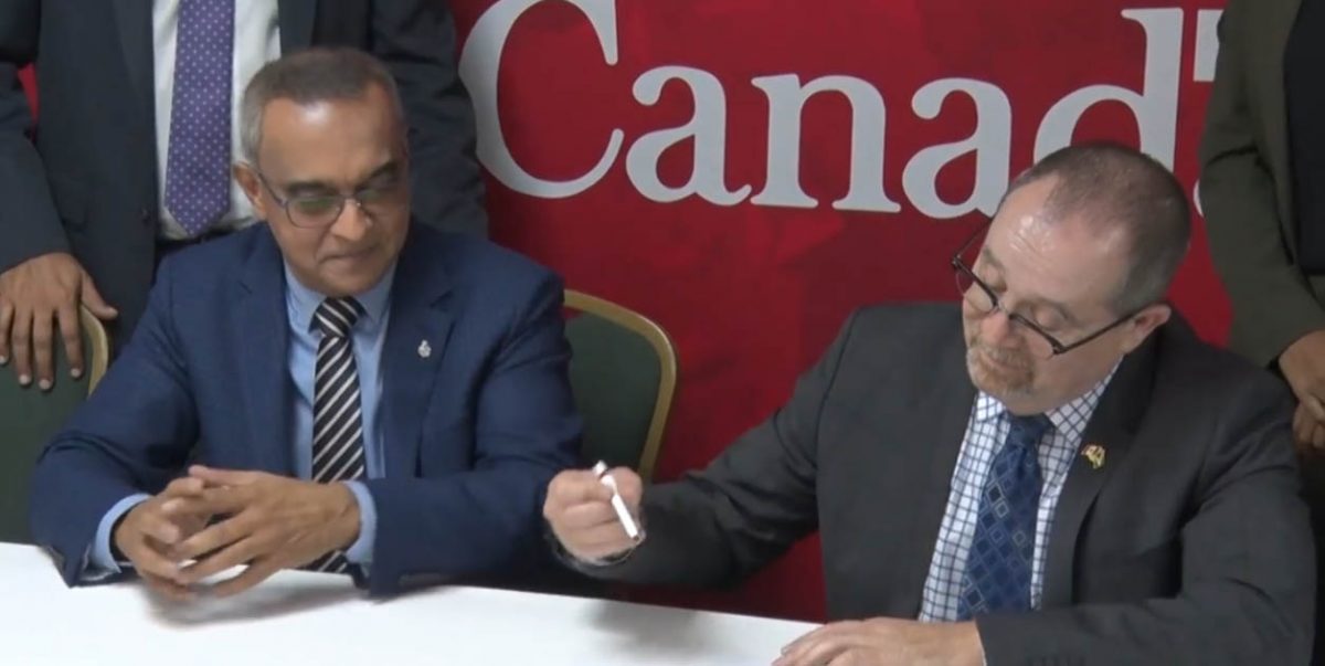Dr Narendra Singh (left) and Canadian High Commissioner Mark Berman at the signing