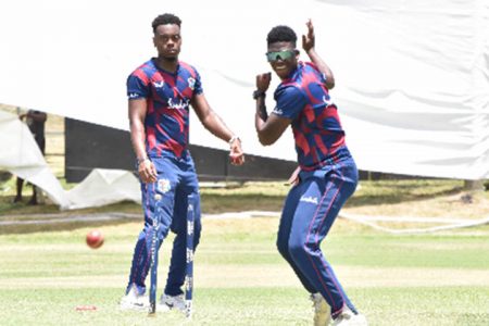 Joshua Bishop (left) watches as Ashmead Nedd sends down a delivery during a net session. (Photo courtesy CWI Media) 