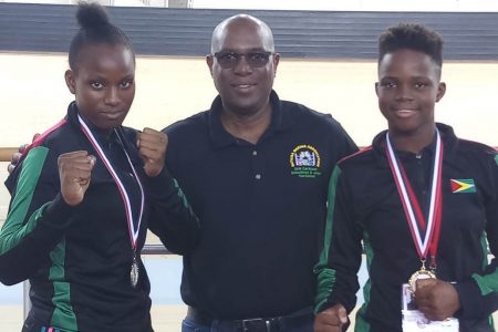 President of the Guyana Boxing Association Steve Ninvalle, centre is flanked by Abiola, left and Alesha Jackman.
