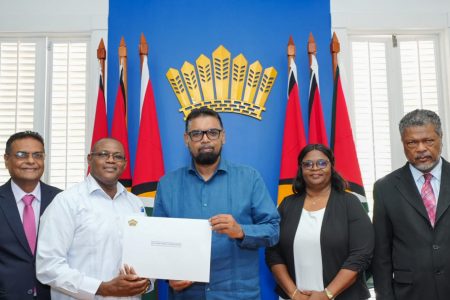 President Irfaan Ali (centre) with the instrument of appointment for Reverend Rodwell Alphonso Porter (second from left). At right is Charles Joseph Ogle. (Office of the President photo)
