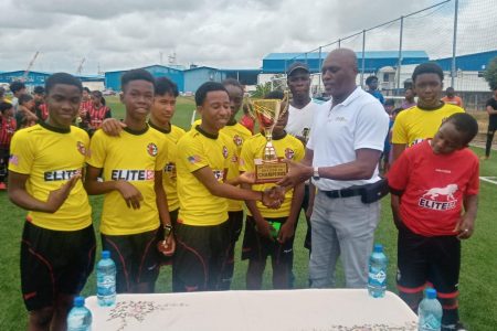 Timehri Panthers receiving the EBFA Tiger Rentals U13 Championship trophy from GFF General Secretary Ian Alves