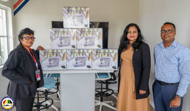 Minister of Human Services and Social Security, Dr. Vindhya Persaud (second from right) along with WIIN coordinator, Sanjay Pooran (right) receives over 100 sewing machines from Silvie’s Industrial Solutions’ Deepawattie Persaud.