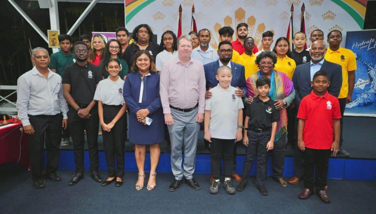  His Excellency President Irfaan Ali, and Barbados’ Prime Minister Mia Mottley pose for a photo opportunity with British Grandmaster Nigel Short following the conclusion of a simultaneous exhibition at State House on Tuesday where Short played 20 local players and made short shrift of them defeating all and sundry ending with a 20-0 record. (Office of the President Photo)
