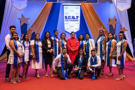 Some of the graduates posed with the Minister of Education Priya Manickchand and Minister of Public Service Sonia Parag. (Ministry of Education photo)