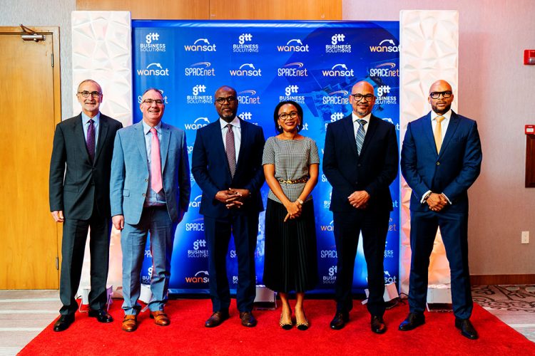 Minister of Tourism, Industry and Commerce, Oneidge Walrond (third from right) with officials of the two companies. (GTT photo)