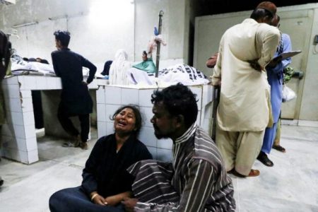 People mourn the death of a relative, who was killed along with others in a stampede during handout distribution, at a hospital morgue in Karachi, Pakistan March 31, 2023. REUTERS/Akhtar Soomro