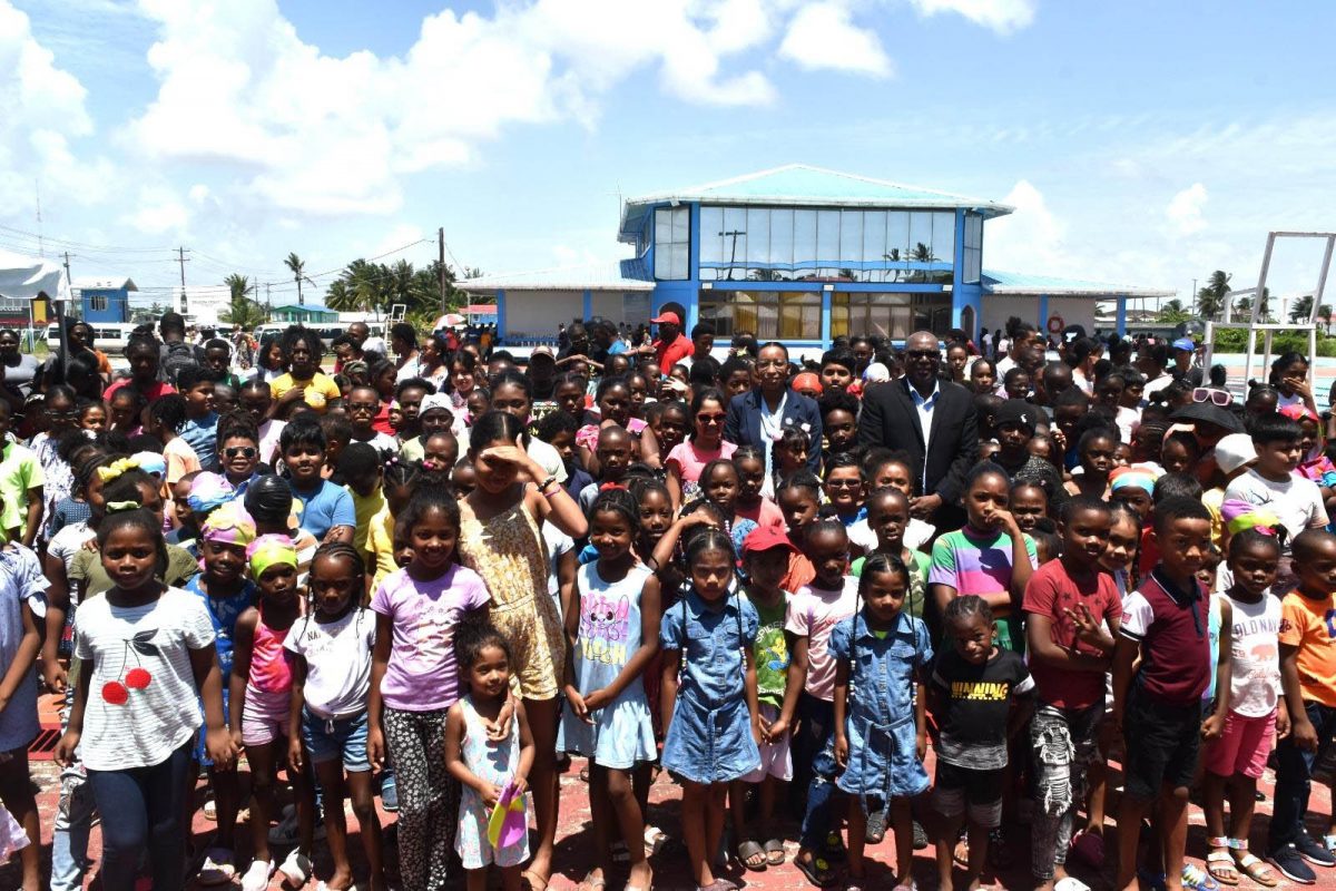 Director of Sport Steve Ninvalle and the over 2000 eager young swimmers at the Ministry of Culture, Youth and Sport Easter Swimming Programme.